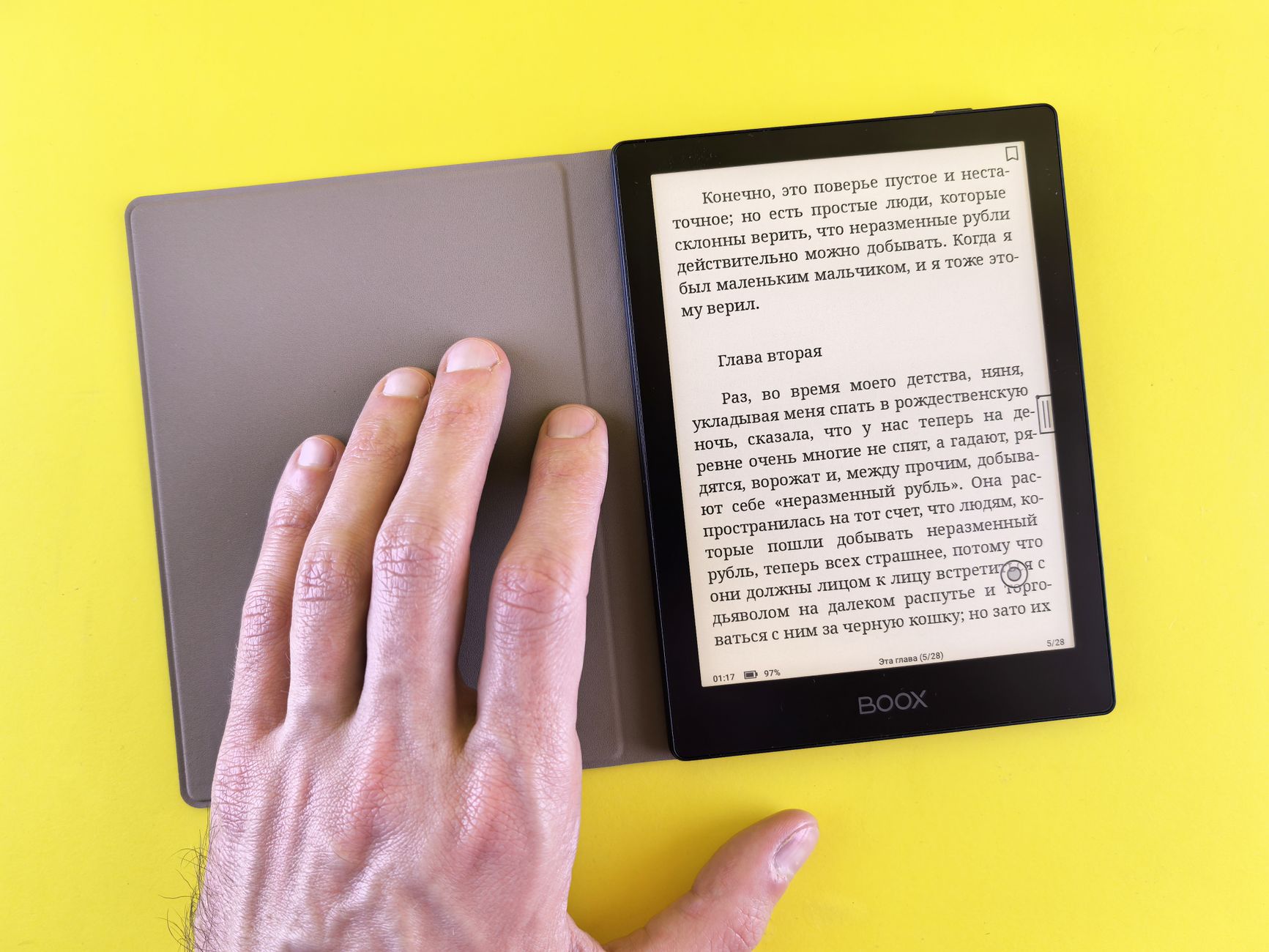 Person using tablet reading e-book guides next to notebook